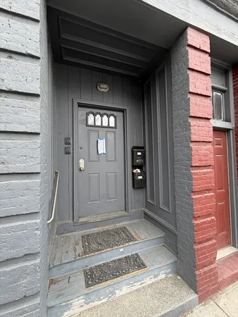 a living room with furniture a dining table and paintings on the wall