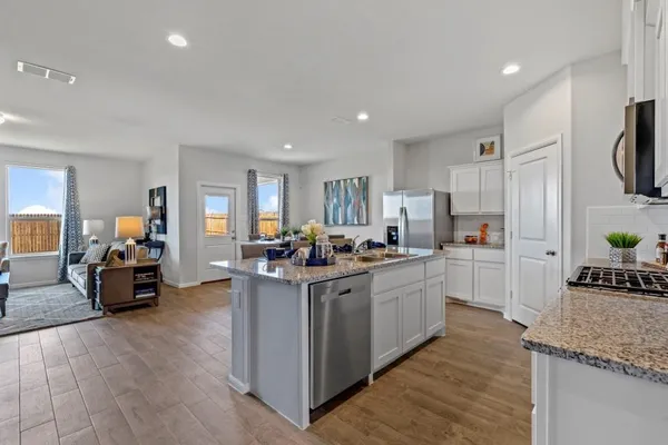 a kitchen with stove and cabinets