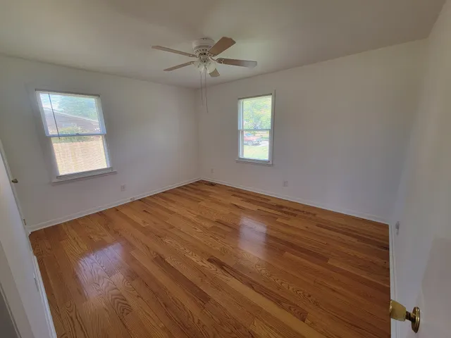 a view of an empty room and a window