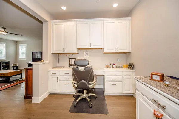 a view of workspace with wooden floor lounge chair and windows