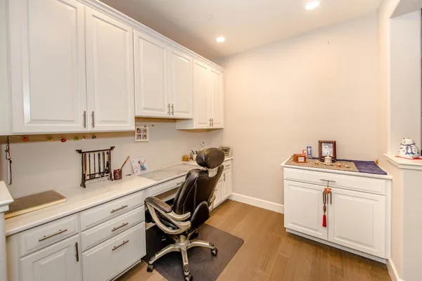 a kitchen with granite countertop white cabinets and white appliances
