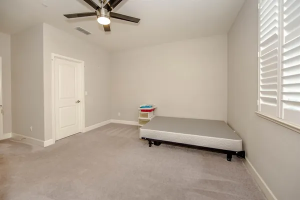 a room with a white bed and a chandelier