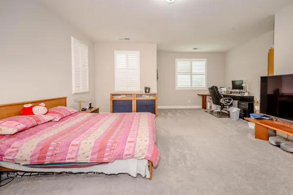 a bedroom with a bed and dresser