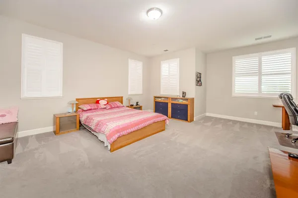 a bedroom with a bed and a couch