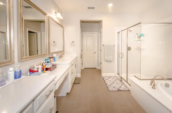a bathroom with a tub sink and mirror