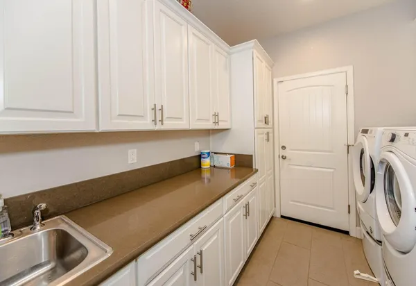 a kitchen with a sink and a washer dryer