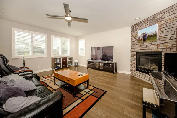 a living room with furniture fireplace and flat screen tv