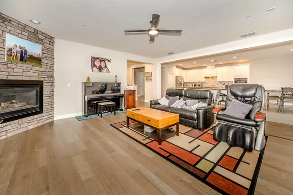 a living room with furniture a fireplace and a flat screen tv