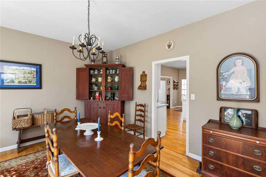 108 Pearman Drive Pendleton, SC 29670 - Photo 16 of 50 This warm dining area features rich wood flooring and a classic chandelier, perfect for intimate gatherings.