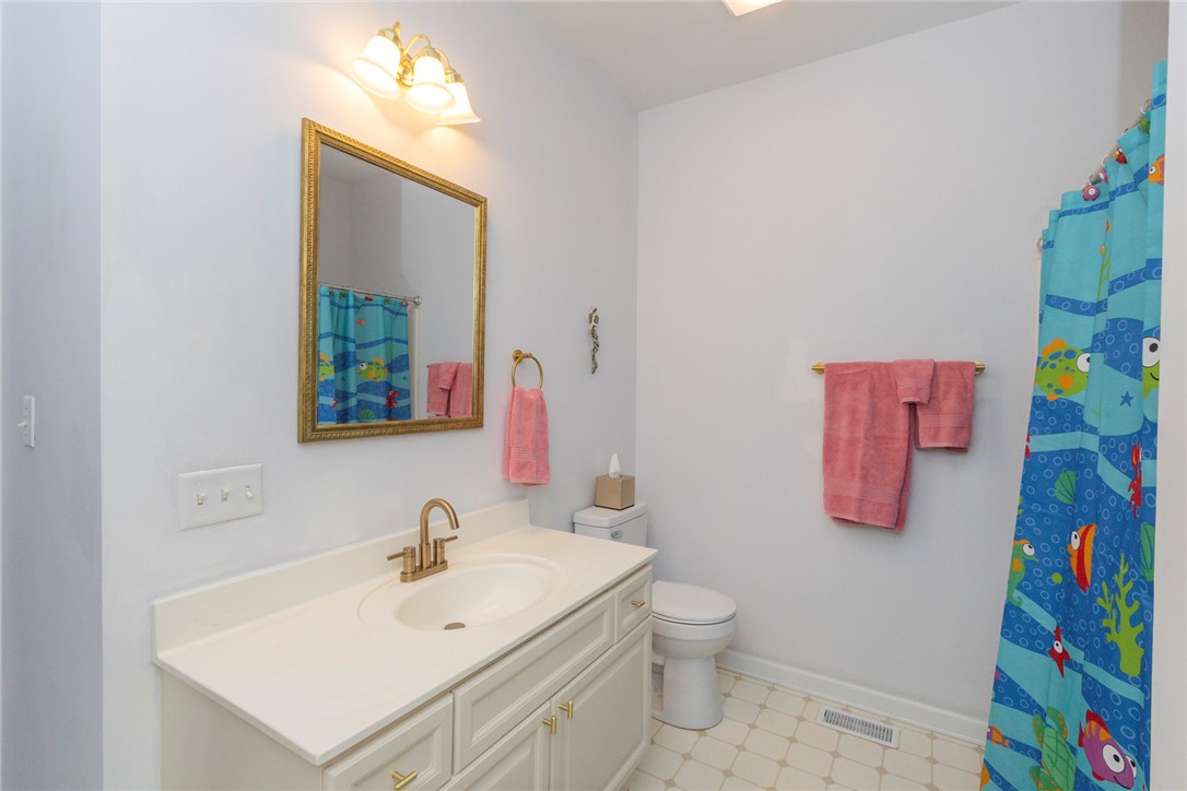 108 Pearman Drive Pendleton, SC 29670 - Photo 23 of 50 This bathroom features a single vanity, a toilet, and a bathtub with a shower curtain.