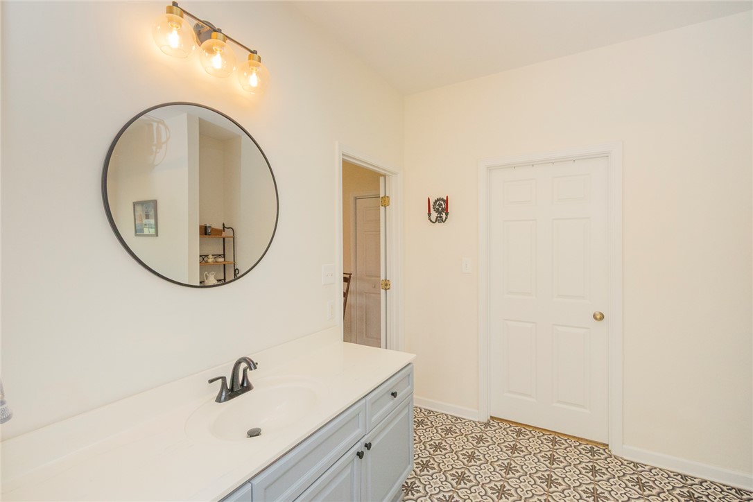 108 Pearman Drive Pendleton, SC 29670 - Photo 29 of 50 This bright bathroom features a vanity with a stylish sink, elegant mirror, and patterned tile flooring.