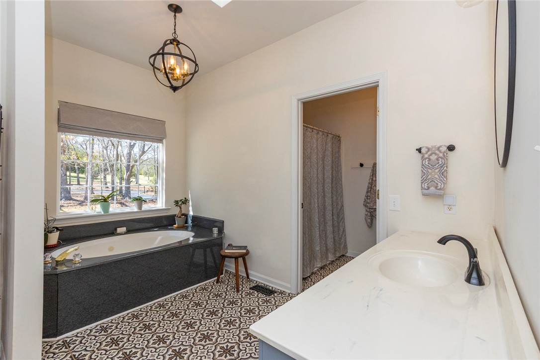 108 Pearman Drive Pendleton, SC 29670 - Photo 30 of 50 This serene primary bathroom offers a large soaking tub and a bright vanity area.