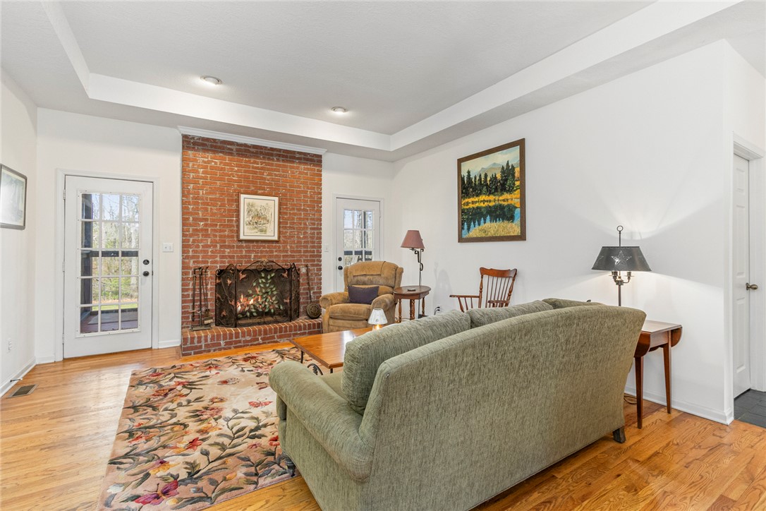 108 Pearman Drive Pendleton, SC 29670 - Photo 4 of 50 This inviting living space features warm hardwood floors and a cozy brick fireplace.