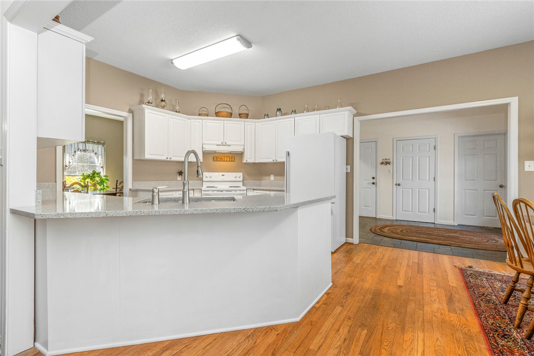 108 Pearman Drive Pendleton, SC 29670 - Photo 8 of 50 This kitchen features a bright and functional layout with hardwood flooring and granite counters.