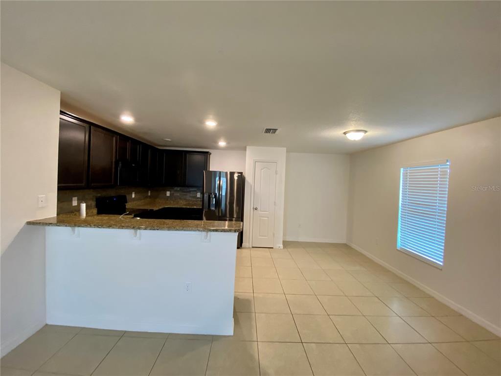 8659 Silverbell Loop Brooksville, FL 34613 - Photo 11 of 36 a view of kitchen with stainless steel appliances a refrigerator and a stove top oven