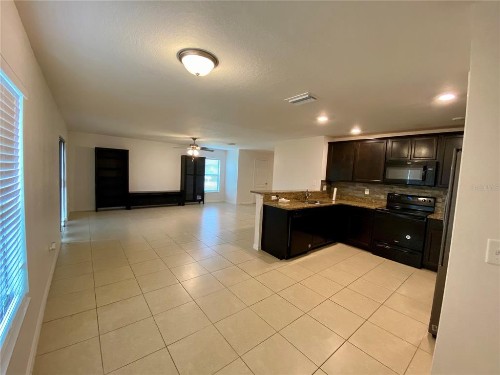 8659 Silverbell Loop Brooksville, FL 34613 - Photo 12 of 36 a kitchen with a sink and cabinets