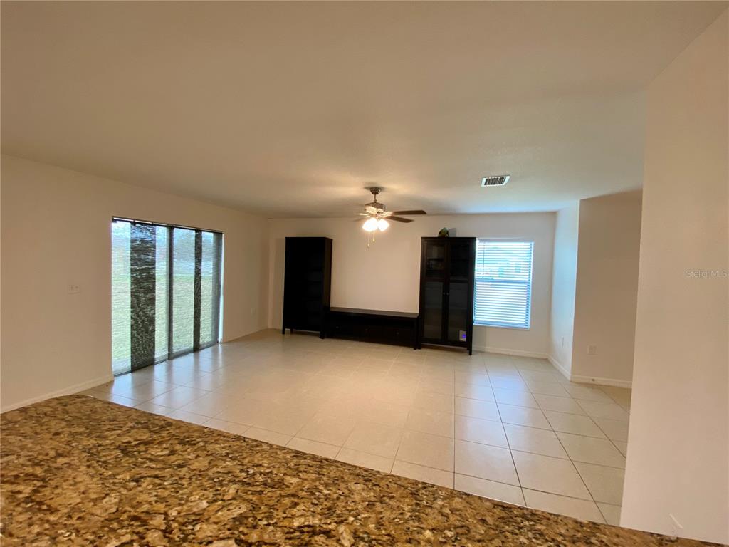 8659 Silverbell Loop Brooksville, FL 34613 - Photo 17 of 36 a view of an empty room with a fireplace
