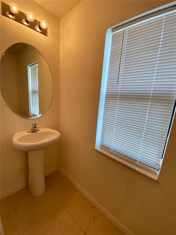 8659 Silverbell Loop Brooksville, FL 34613 - Photo 18 of 36 a bathroom with a sink and a mirror