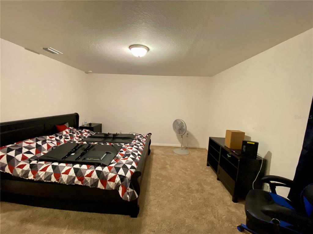 8659 Silverbell Loop Brooksville, FL 34613 - Photo 19 of 36 a bedroom with a bed