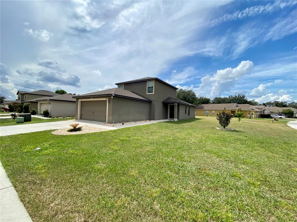 8659 Silverbell Loop Brooksville, FL 34613 - Photo 2 of 36 a swimming pool with outdoor seating and yard