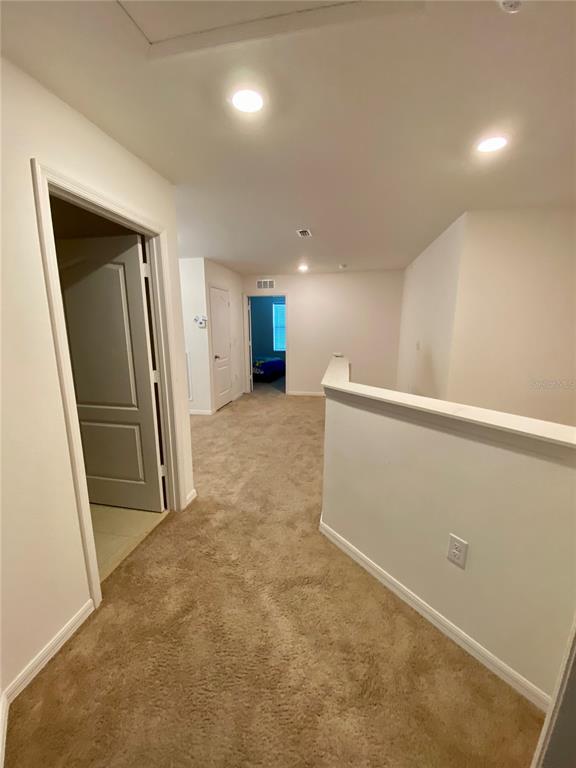 8659 Silverbell Loop Brooksville, FL 34613 - Photo 26 of 36 an empty room with a fireplace and a projector