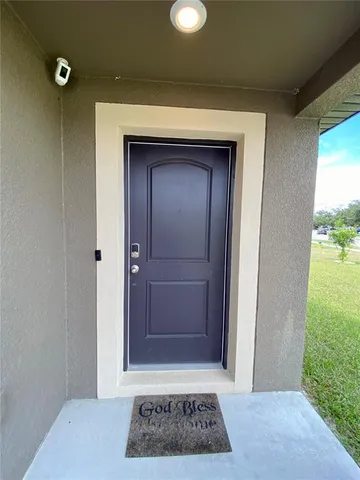 a view of a kitchen with a sink and a refrigerator
