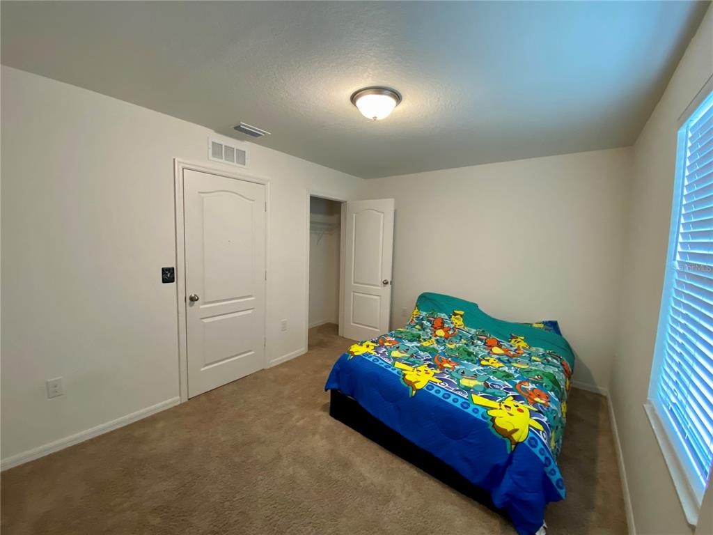 8659 Silverbell Loop Brooksville, FL 34613 - Photo 36 of 36 a bedroom with a bed and a dresser in it