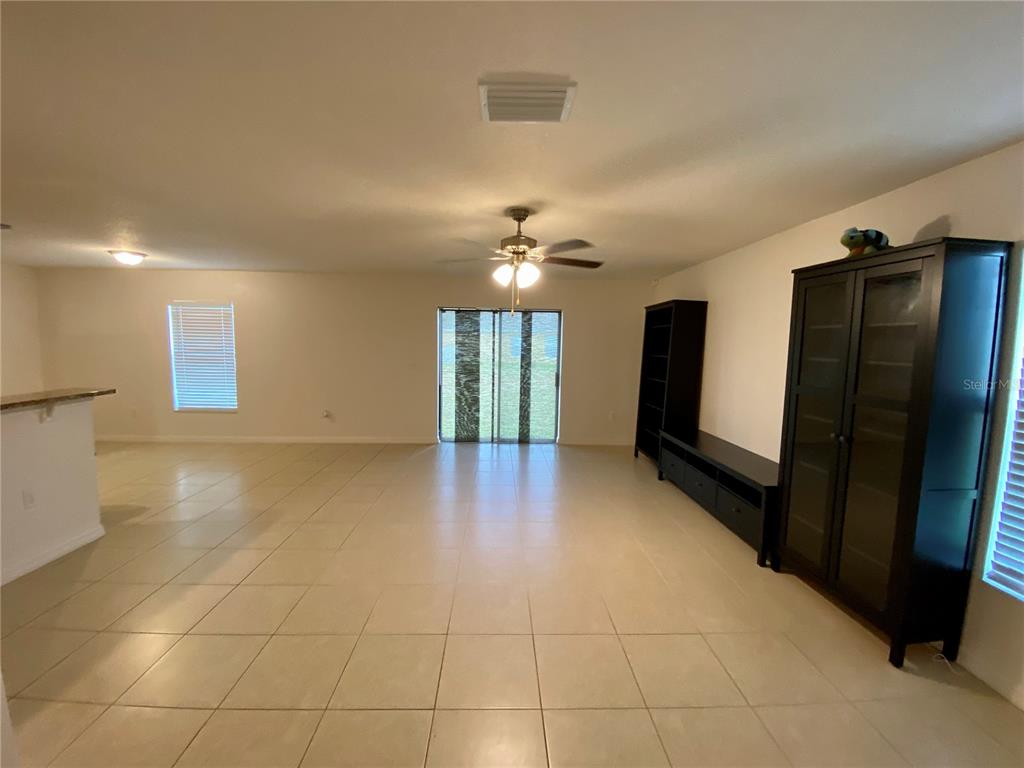 8659 Silverbell Loop Brooksville, FL 34613 - Photo 4 of 36 a view of a kitchen with a sink and a refrigerator