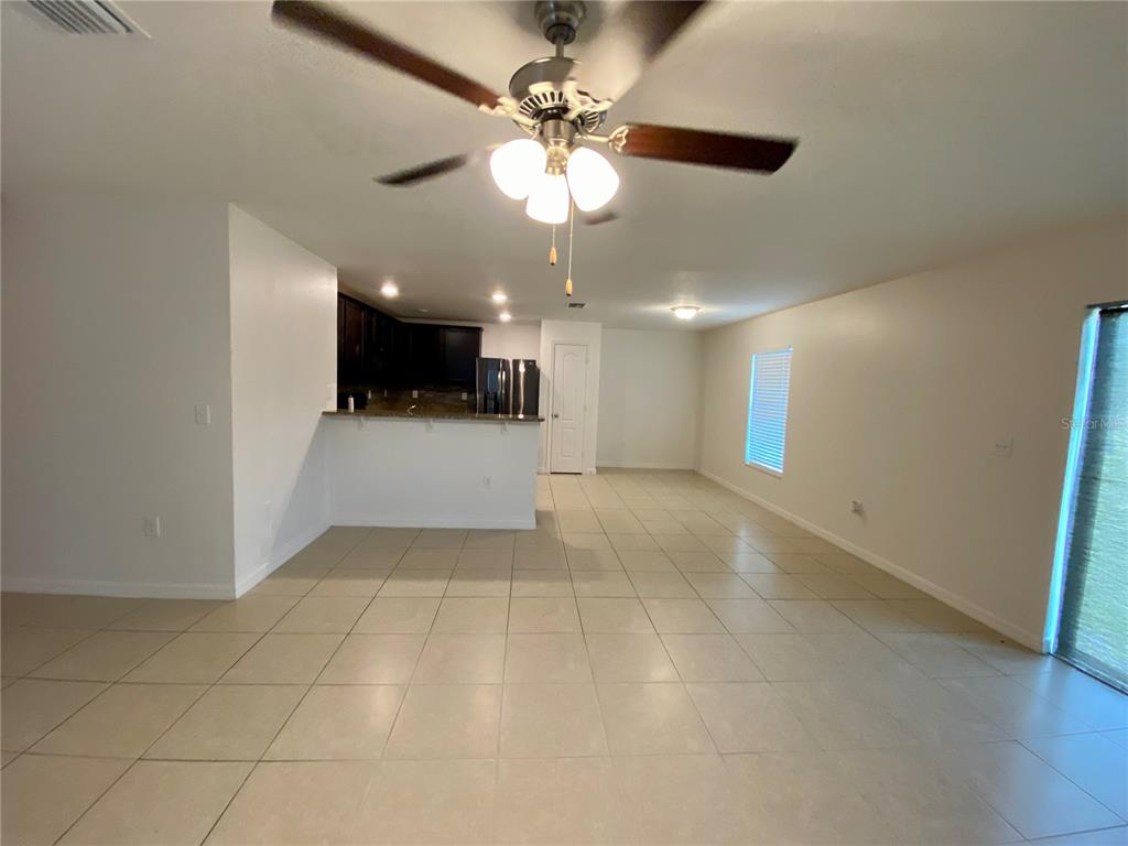 8659 Silverbell Loop Brooksville, FL 34613 - Photo 6 of 36 a view of a livingroom and a chandelier fan