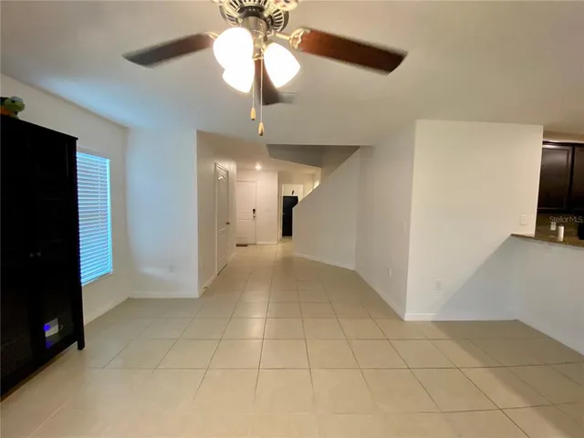 a kitchen with kitchen island granite countertop a sink and a refrigerator