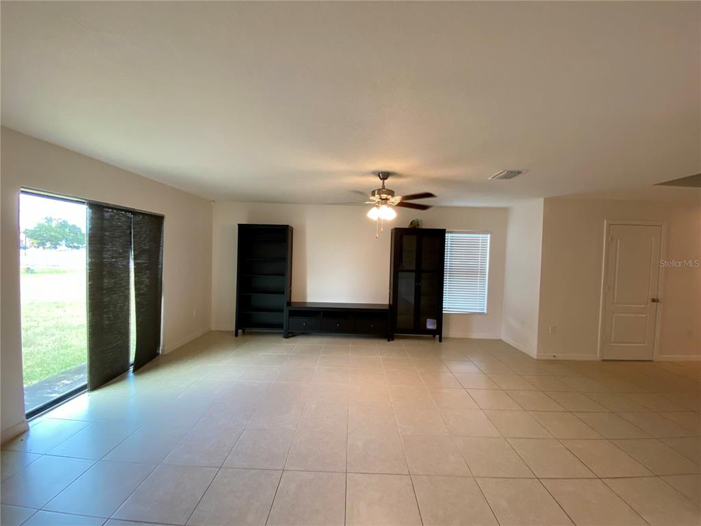 8659 Silverbell Loop Brooksville, FL 34613 - Photo 10 of 36 an empty room with closet and a chandelier fan
