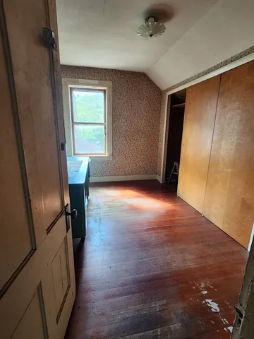 a view of a livingroom with furniture and hardwood floor