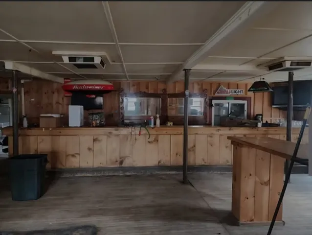 a kitchen with cabinets and wooden floor