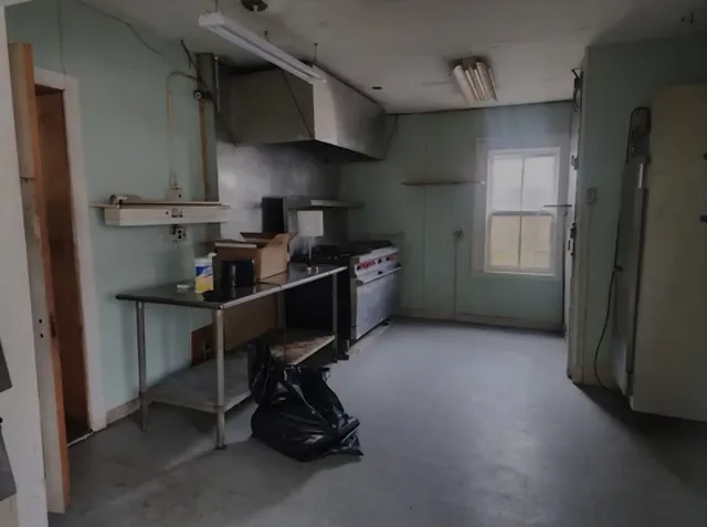 a kitchen with a sink a stove and a refrigerator
