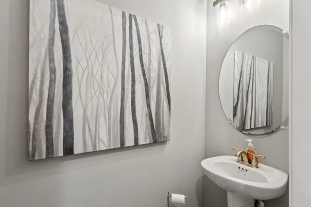 a bathroom with a sink a mirror and vanity