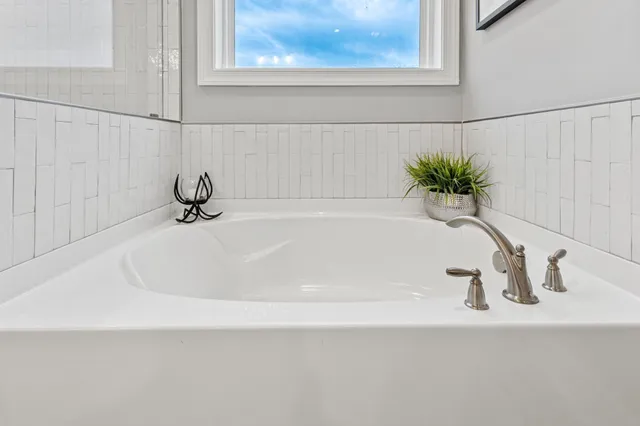 a white bath tub sitting next to a window
