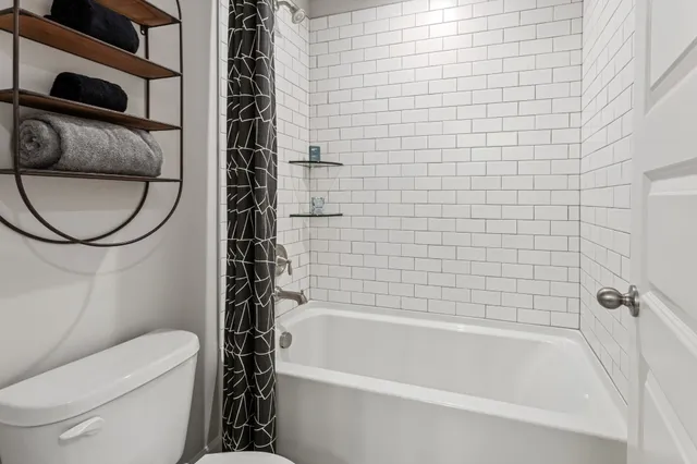 a bathroom with a toilet and a bathtub