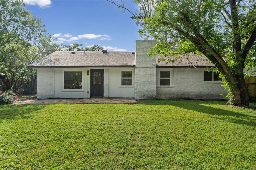 1406 North Georgetown Street Round Rock, TX 78664 - Photo 33 of 34 A private backyard oasis with mature trees and a tranquil lawn awaits.