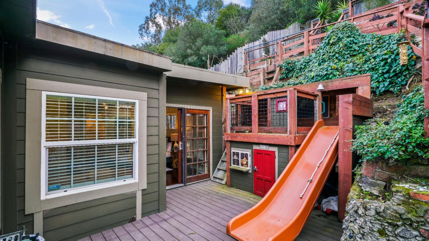 338 Kings Road Brisbane, CA 94005 - Photo 18 of 53 a backyard of a house with wooden floor and stairs