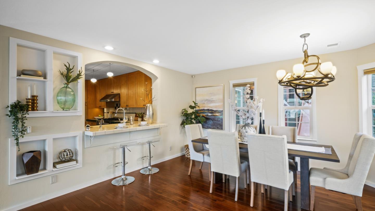 338 Kings Road Brisbane, CA 94005 - Photo 31 of 53 a view of a dining room with furniture a chandelier and wooden floor