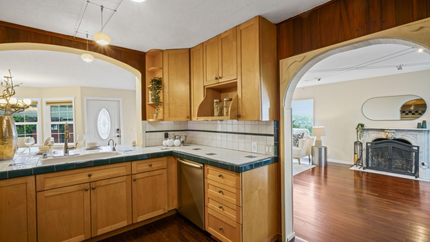 338 Kings Road Brisbane, CA 94005 - Photo 33 of 53 a kitchen with a sink cabinets and wooden floor