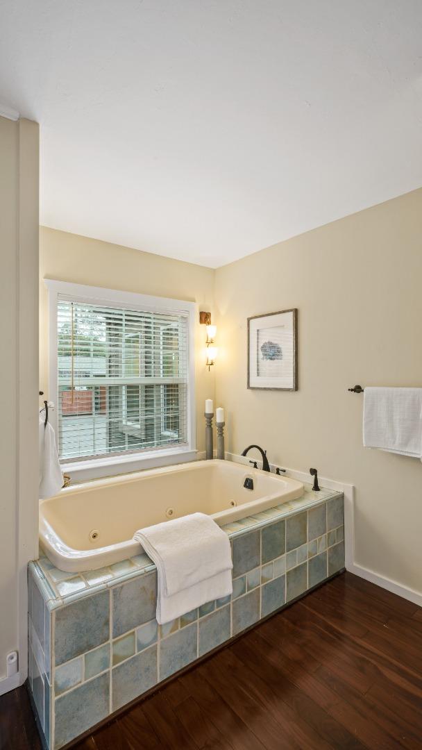 338 Kings Road Brisbane, CA 94005 - Photo 40 of 53 a bedroom with a bed and wooden floor