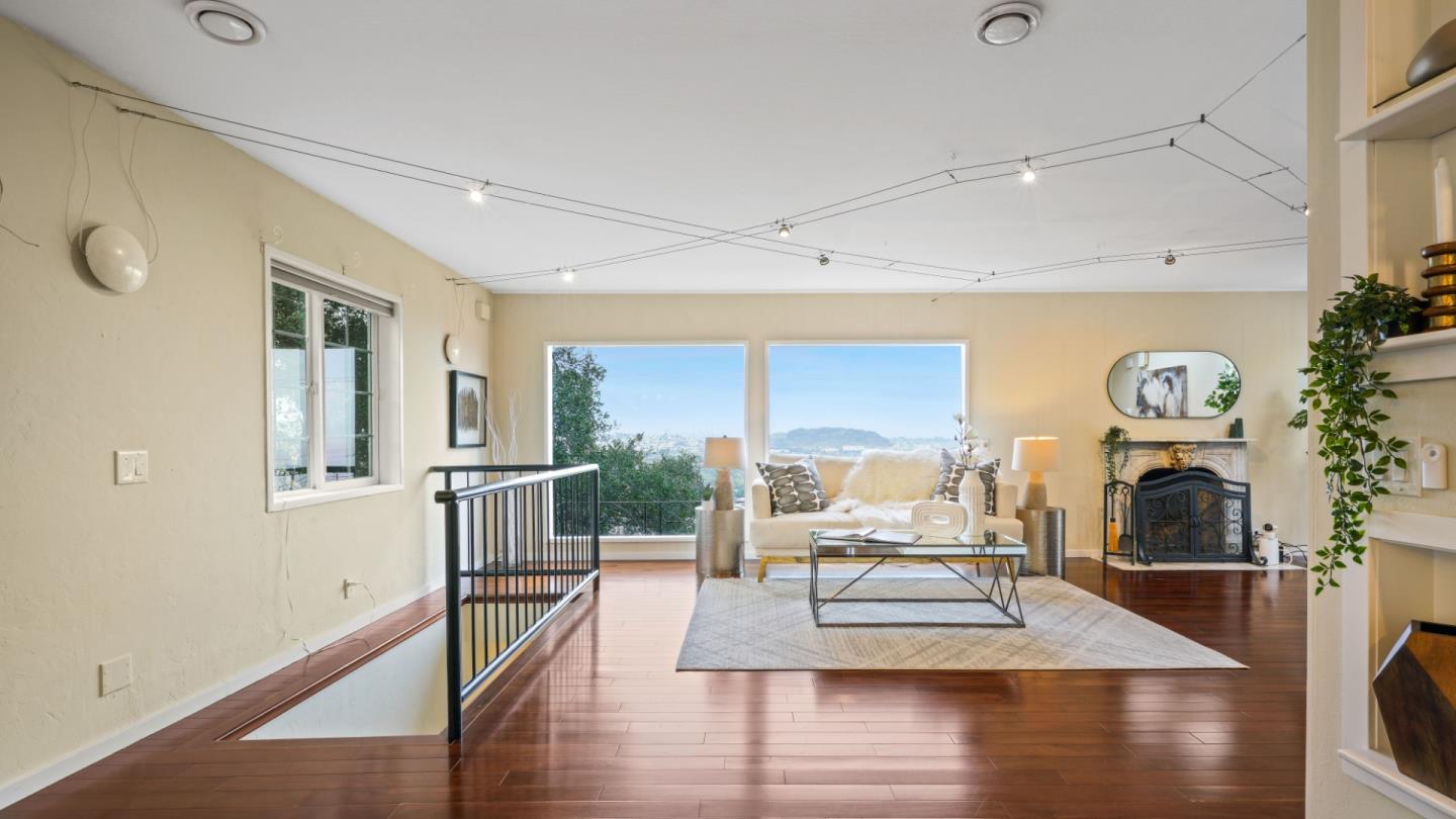 338 Kings Road Brisbane, CA 94005 - Photo 4 of 53 a living room with furniture and a fireplace