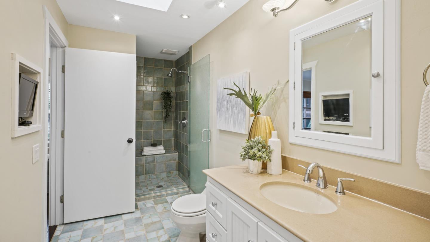 338 Kings Road Brisbane, CA 94005 - Photo 44 of 53 a bathroom with a granite countertop sink a toilet and shower