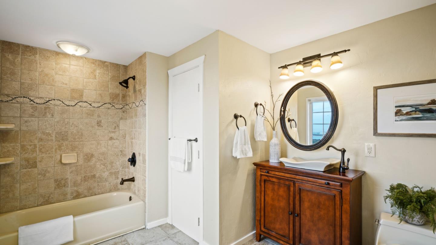 338 Kings Road Brisbane, CA 94005 - Photo 50 of 53 a bathroom with a sink a mirror and a shower