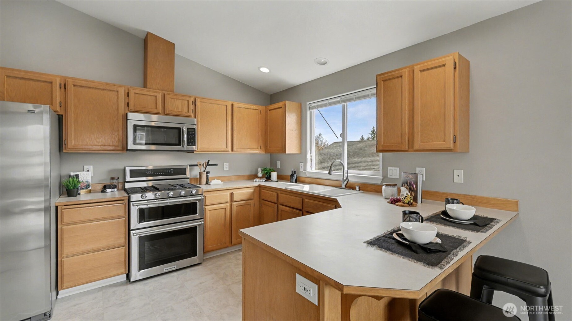132 76th Place Southwest Everett, WA 98203 - Photo 15 of 36 a kitchen with kitchen island granite countertop a sink appliances and cabinets