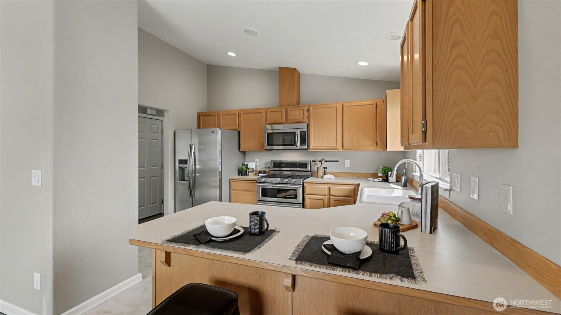 132 76th Place Southwest Everett, WA 98203 - Photo 16 of 36 a kitchen with a refrigerator a stove and a sink