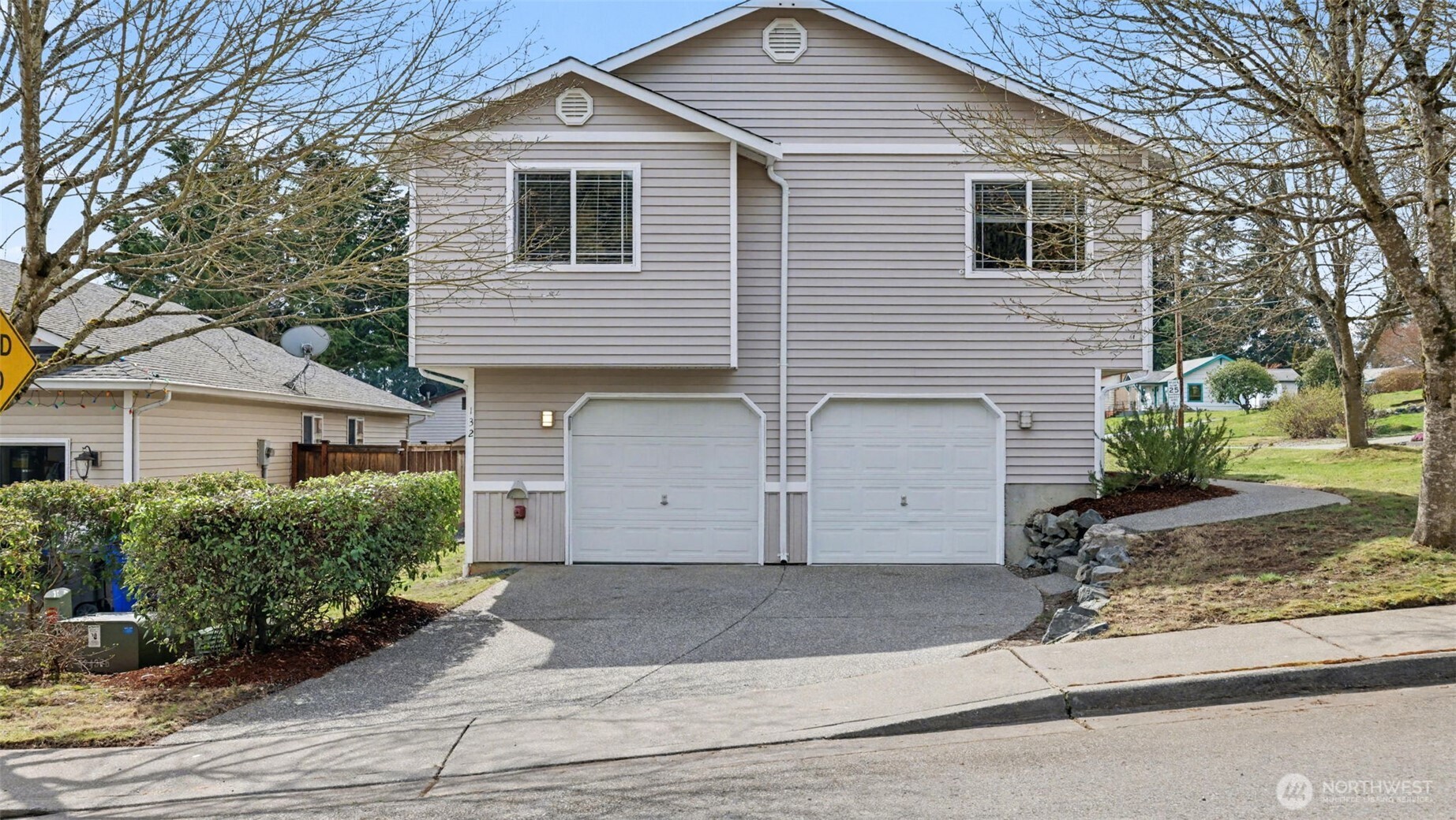 132 76th Place Southwest Everett, WA 98203 - Photo 2 of 36 a front view of a house with a yard and garage