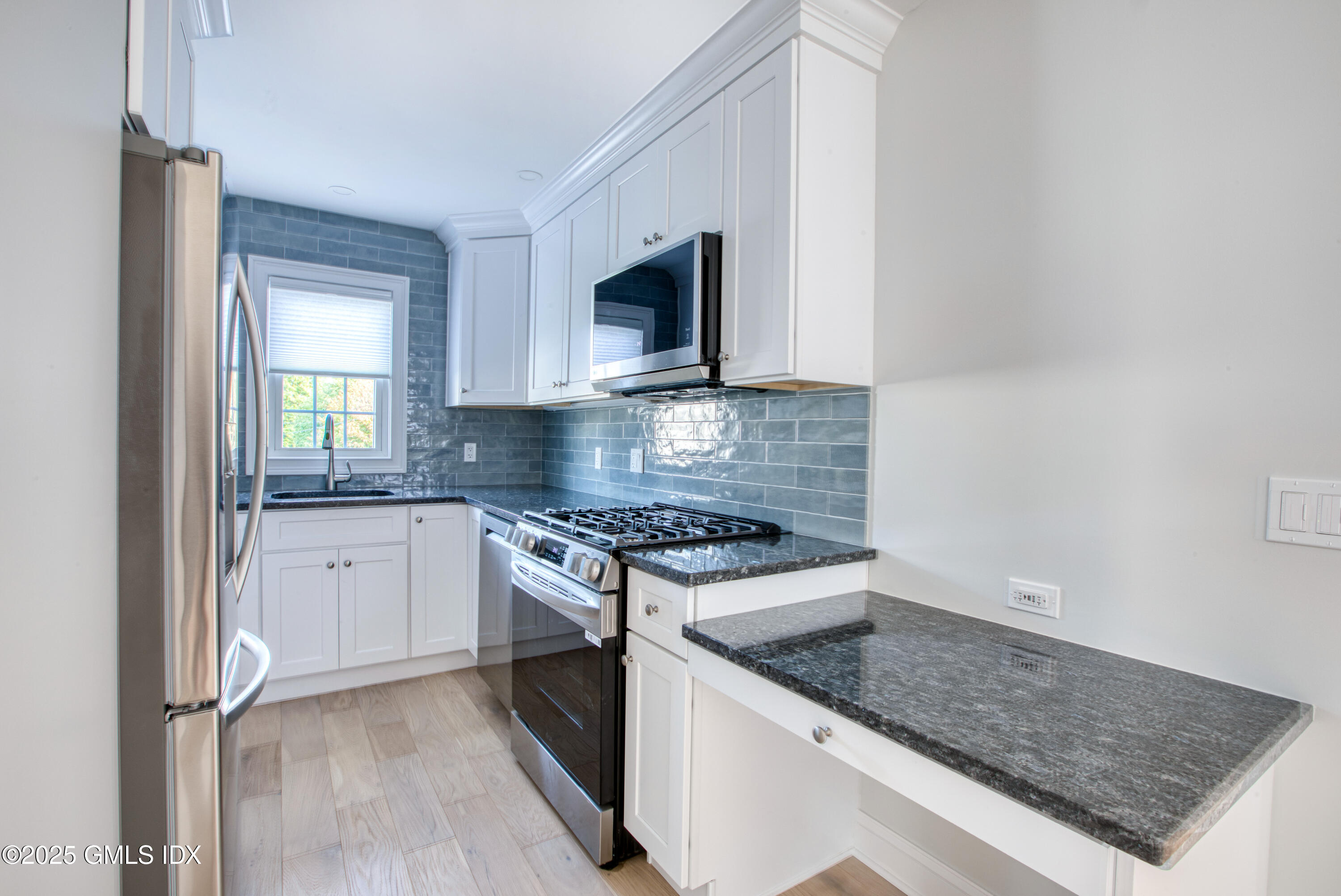 66 Ute Place, Unit C Greenwich, CT 06830 - Photo 7 of 18 a kitchen with stainless steel appliances granite countertop a stove a sink and a microwave