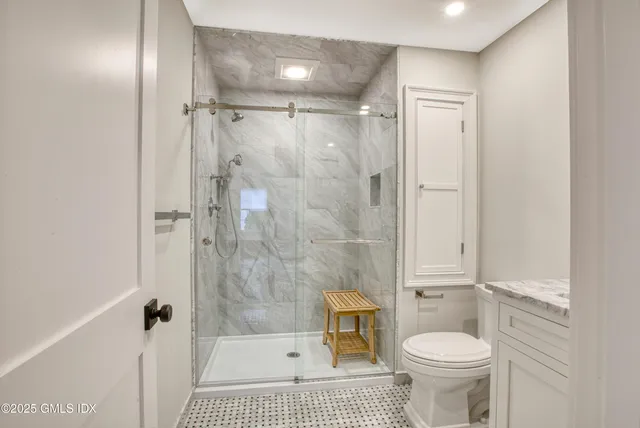 a bathroom with a sink a toilet and shower